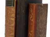 trois livres posés sur une table blanche