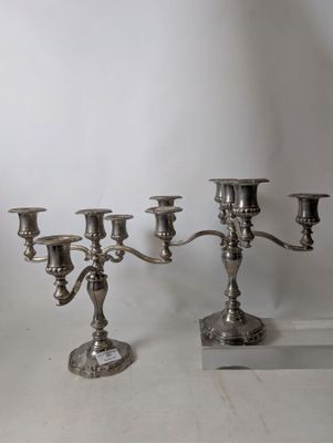 a silver candelab with five candles on it