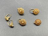 four pairs of gold earrings and a pair of ear rings