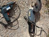 a drill and a cord on the ground next to a drill