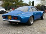 an image of a blue sports car parked in a parking lot