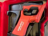 a red tool in a red box with a black handle