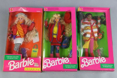 three barbie dolls are in their boxes on a table