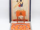 an orange pinball game in a metal case with a basketball player on it