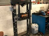 a machine that is sitting in a garage next to a trash can