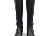 pair of black rain boots on a white surface with a white background
