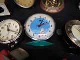 many different types of clocks on a black table