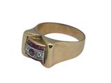 an image of a close up of a gold ring with a ruby stone