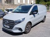 a white van that is parked on the side of the road
