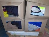 three boxes that have clothes in them on a pallet