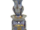 a blue and gold vase with a bird on it