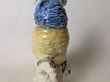 a figurine of a bird with a hat on it ' s head