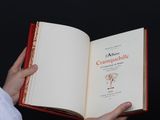a person holding an open book in their hands
