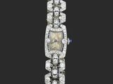 une montre-bracelet Art déco sertie de diamants et de saphirs, signée Cartier