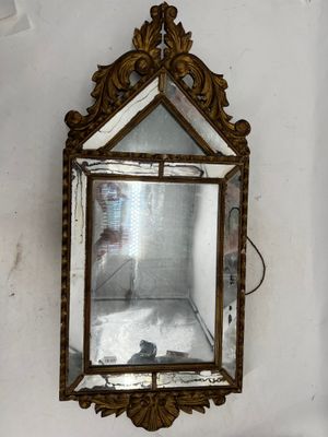 a mirror hanging on the wall in the corner of a room