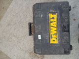 a tool box sitting on the ground next to a pair of shoes