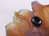 a close up of a glass object with a black bead on it