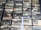 many old black and white photos are on display on a table