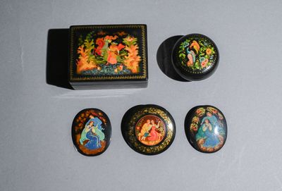 three small decorative items are sitting on a table next to a box