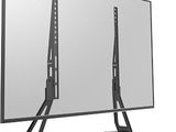 a flat screen tv sitting on top of a stand next to a mirror