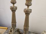 two candles that are sitting on a marble table
