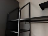 a black shelf with shelves and shelves on it in a room