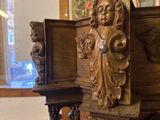 a wooden bench with a carved head on it