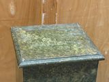 a green marble box sitting on top of a wooden table