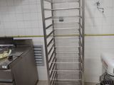 a metal rack that is in the middle of a kitchen
