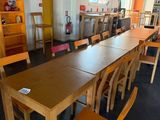 tables and chairs in a room with a bookcase and a ceiling fan