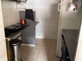 a small kitchen with a stove, sink, and refrigerator in it
