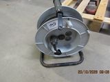 an image of a reel on a cart in a warehouse