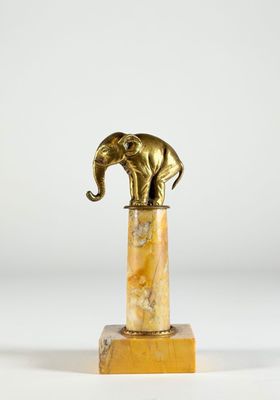 une statue d'éléphant posée sur un socle en marbre, sur fond blanc