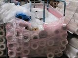 several rolls of plastic are stacked on top of each other in a warehouse