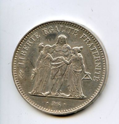a close up of a coin on a white surface with a white background