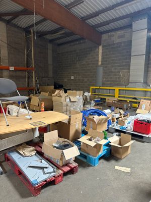 une pièce avec beaucoup de cartons et des cartons sur le sol