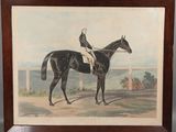 painting of a jockey on a black horse in a wooden frame