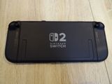 a close up of a nintendo switch lite sitting on a wooden floor
