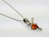 a silver necklace with an orange glass bead on it