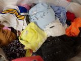 a white bag filled with lots of different types of clothing
