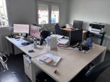un bureau sur lequel se trouvent deux ordinateurs et une imprimante