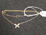a close up of a necklace with a butterfly on it