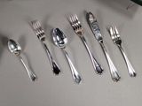 a lot of spoons and forks that are on the table
