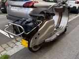 a silver motorcycle parked on the side of the street