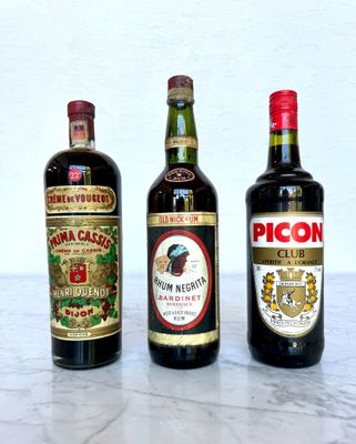 three bottles of wine sitting on a marble table