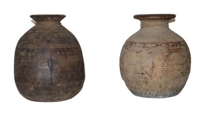 two vases sitting next to each other on a white surface