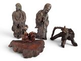three chinese carved figurines of men and animals on a white background