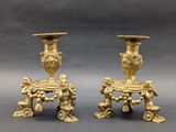 pair of antique brass candlesticks with cherenshes and cherenshes