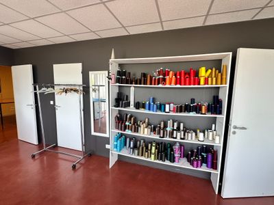 a room with a lot of hair products on the shelves