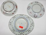 three plates with designs on them sitting on a white surface